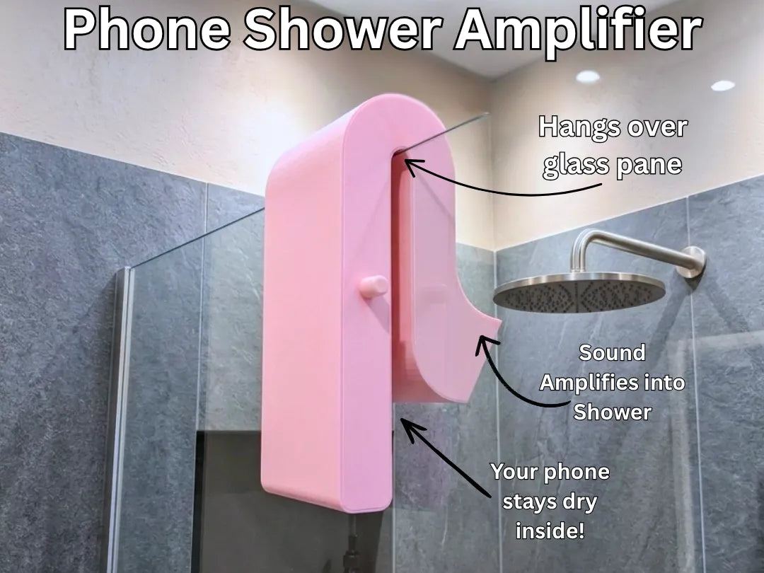 Phone shower amplifier hanging on glass shower door
